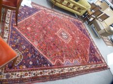 An Afghan rug having central diamond with floral design, 305 x 229 cms