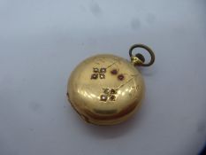 14K yellow gold cased small ladies pocket watch inset with red and clear stones, marked 585, diamete