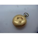 14K yellow gold cased small ladies pocket watch inset with red and clear stones, marked 585, diamete