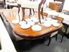 An antique French walnut extending dining table having two leaves, 244 cms, and a set of six barback
