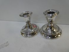 A pair of silver candlesticks hallmarked Birmingham 1916 W H Haseler Ltd. 9cm high approx with decor