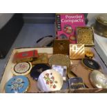 A quantity of powder compacts and a collector's guide