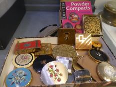 A quantity of powder compacts and a collector's guide