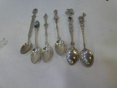 A quantity of silver and white metal teaspoons, each with ornate and decorative handles, foreign sil