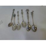 A quantity of silver and white metal teaspoons, each with ornate and decorative handles, foreign sil