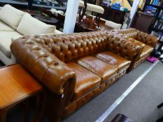 Two similar modern tan leather Chesterfield sofas, the largest 210 cms