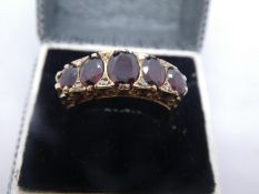 9ct yellow gold Victorian dress ring set with diamond chips and graduated garnets, marked 375, gross