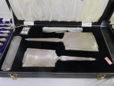 An impressive silver dressing table set comprising of two silver back brushes, silver mirror and a s