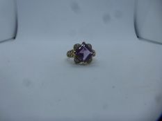 Large contemporary 9ct dress ring set with large square amethyst surrounded by paler stones, marked