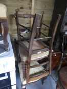 A pair of wooden carved back chairs with floral seats, and three other chairs