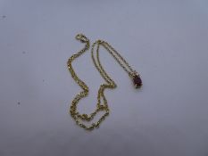 Pretty diameter and ruby pendant hung on a 18ct yellow gold fine belcher chain marked 750, approx 4g