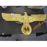 Cast metal emblem of the German Imperial Eagle sign, a badge and a dagger