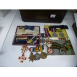 WWI trio of medals, Red Cross badges and sundry