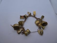 9ct rose gold charm bracelet with yellow gold heart shaped clasp marked 375, hung with 13 charms, ha