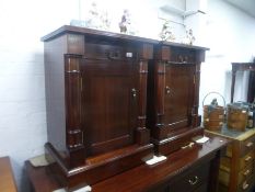 A pair of reproduction mahogany bedside cupboards having one drawer to each