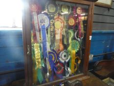 Antique mahogany glazed display case containing dog show rosettes, and a corner wot not