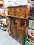 Tall mahogany cabinet believed to be repurposed piece at some point in its life, with column support