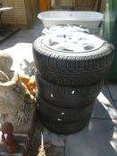 A set of 4 mangels, alloy wheels and tyres by Pirelli