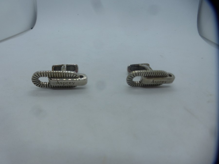 A pair of hallmarked silver cufflinks by Asprey
