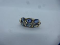 Contemporary 9ct dress ring set with two rows of oval cut blue stones spaced by diamond chips, marke