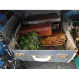 A vintage suitcase to include a metal carry container with green glasses, leather satchels and cases