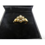 Pretty 18ct yellow gold ring with seed pearls, forming a flower with central diamond chip, marked 18