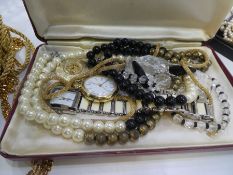 Two cases containing various costume jewellery including various strings pearls, watches, gold plate