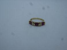 Contemporary 9ct yellow gold dress ring set with oval rubies and diamond chips, size O, approx 2.7g