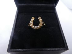 9ct yellow gold dress ring designed as a horseshoe set with seed pearls, marked 9ct, size P, weight