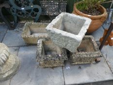 A pair of square stone effect planters, another square one and a rectangular planter some marked Cot