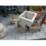 A pair of square stone effect planters, another square one and a rectangular planter some marked Cot