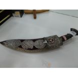 A white metal Kukri knife with ornate pierced and decorative design