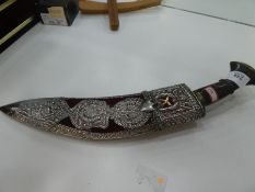 A white metal Kukri knife with ornate pierced and decorative design