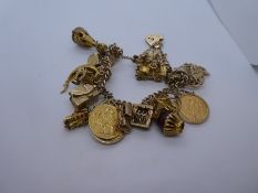 9ct yellow gold charm bracelet with heart shaped clasp and safety chain, hung with 24 charms to incl