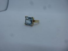 Contemporary 9ct yellow gold dress ring set with square pale blue stone, size Q, marked 375