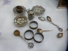 A lot of silver items to include ash tray, silver trinket dishes, napkin rings, spoons and a decorat