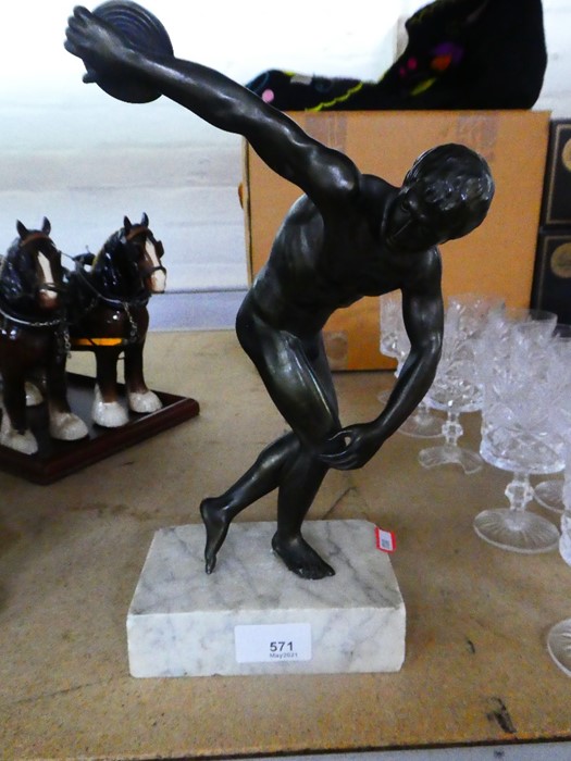 A bronze style figure of discus thrower on white marble base