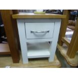 A modern oak side table having one drawer and a small lamp table