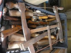 A crate of wooden handled wood working tools
