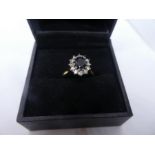 18ct yellow gold ring, with central sapphire surrounded by diamonds, marks worn, size N, approx 3.9g