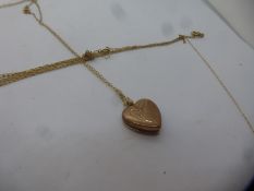 9ct yellow gold heart shaped locket marked 375, on unmarked yellow metal chain, 1.5g approx and a 14