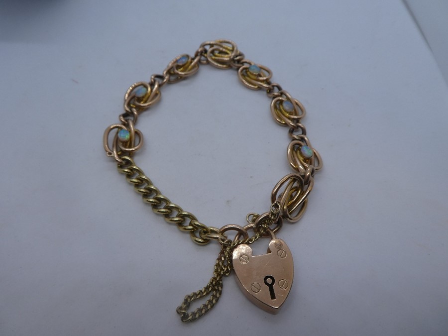 Rose gold bracelet inset with 8 cabochon cut opals, with heart shaped clasp, marked 375, possibly go