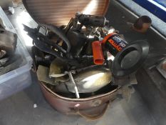 An old hat box full of mixed metal items and blow torches