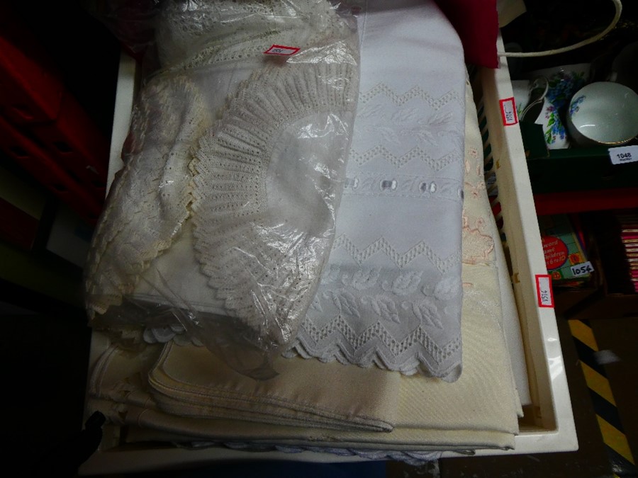 Selection of vintage tablecloths and doilies, some being lace