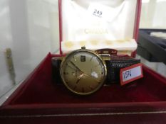 A gent's Omega gold plated watch dating from the 1960 winds and ticks, complete with its original bo