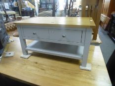 A modern grey coffee table on square legs with an oak top