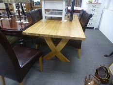 A modern oak oblong dining table having X frame supports and a set of six dining chairs, table 180cm