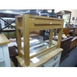 A modern oak hall table having one long drawer with glass shelf below