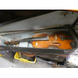 Cased violin, music sheets, and books in a vintage leather case