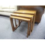 A nest of 3 teak coffee tables